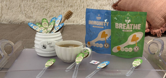 SANA VitaHoney infused honey spoon next to sugar as healthier morning tea sweetener swap