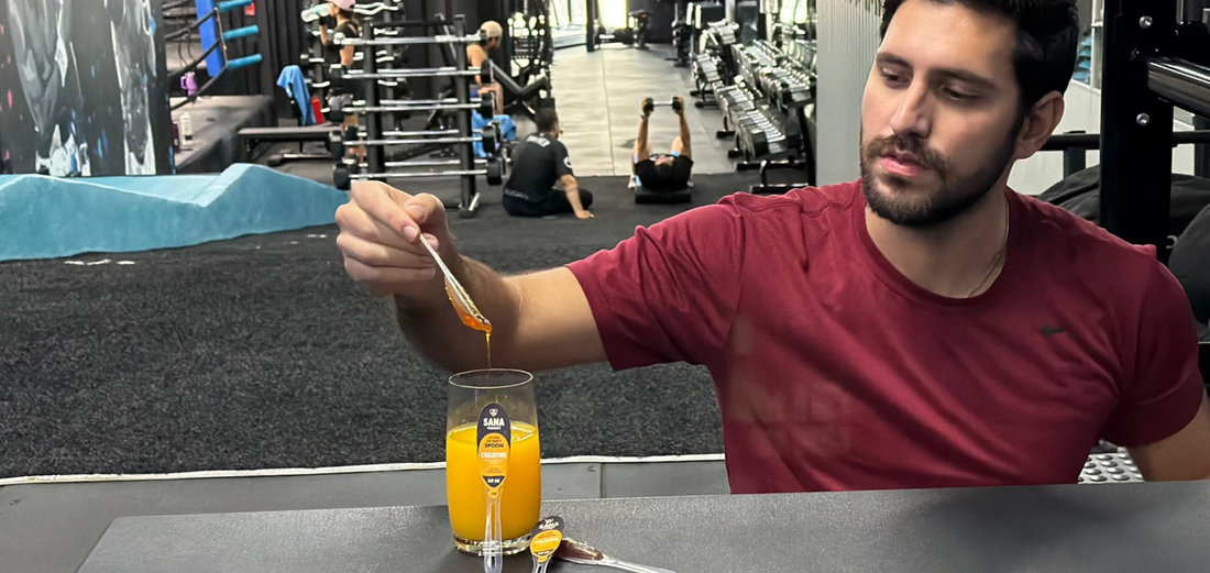 Athlete using SANA VitaHoney creatine honey spoon as natural pre-workout fuel before training