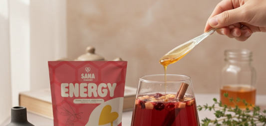 Person stirring a SANA VitaHoney honey spoon into a cup of tea for morning ritual