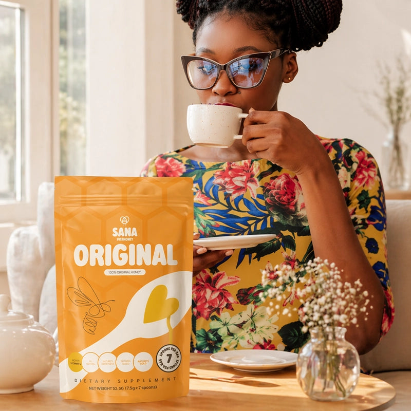 Woman drinking from a mug with a Sana VitaHoney Original Spoon package in the foreground.